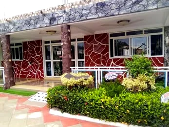 Red stone walls and flowerbeds at the entrance