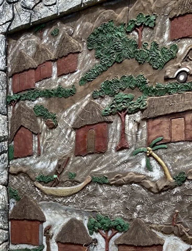 Hand-made relief mural of village life on the walls of The Pelican Hotel