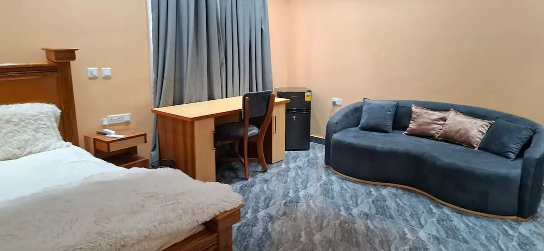 VVIP bedroom 1 with a king bed, sofa and desk