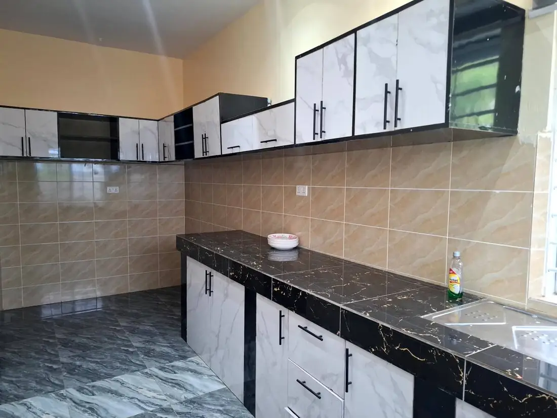 The fitted VVIP kitchen with dark marble-look counters