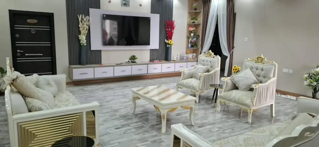The VVIP living room: cream and gold lounge suite, marble floors