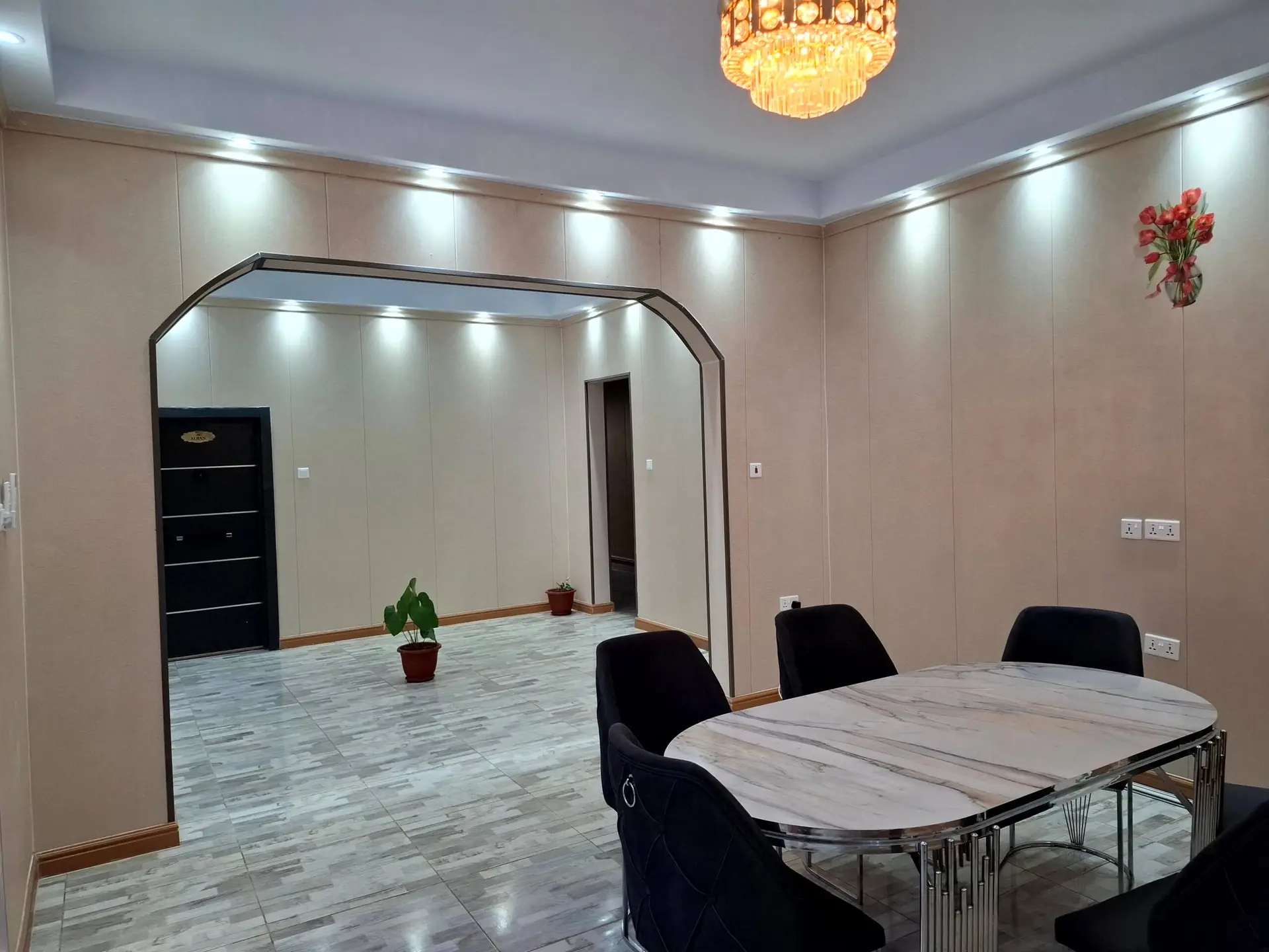 The VVIP dining area under an arched ceiling with a chandelier